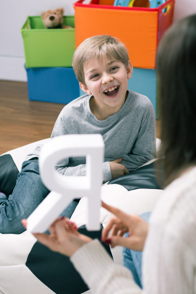 Shot of a speech therapist and a happy little boy