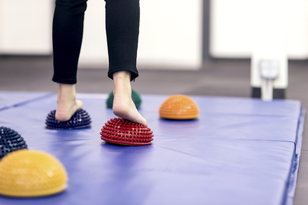 Feet stepping on therapy balls to practice balance Feet stepping on therapy balls to practice balance at a PT clinic